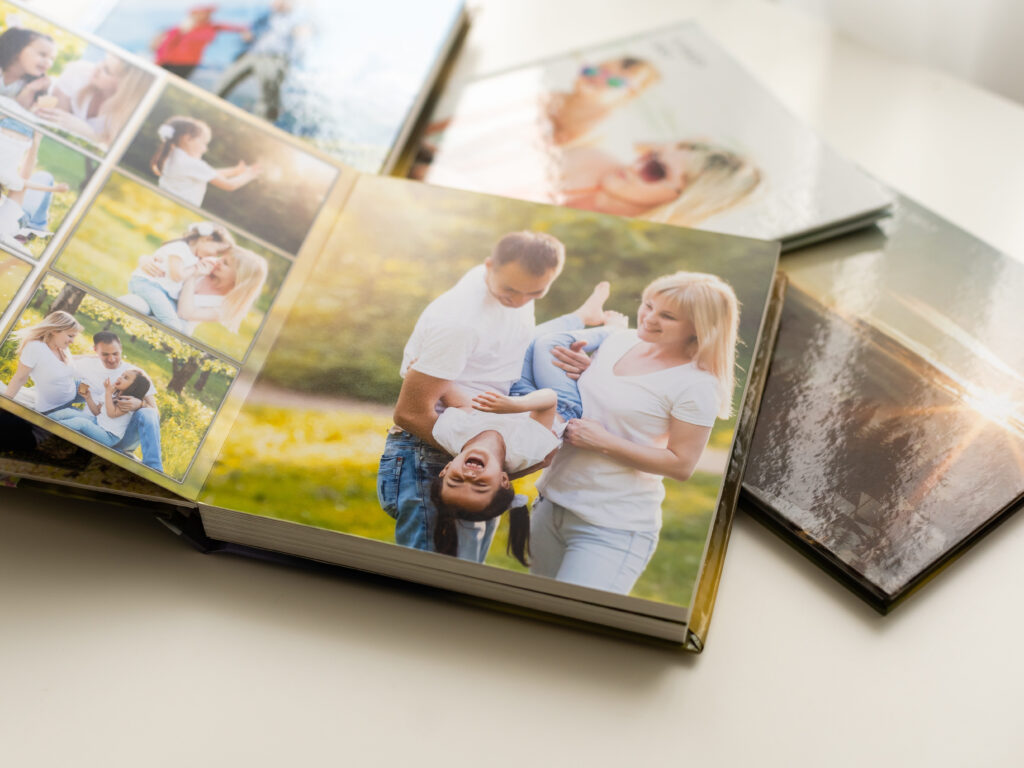 A Southern Oregon Photo Manager shares a photo of several printed photo books, which is a service she provides for her clients.