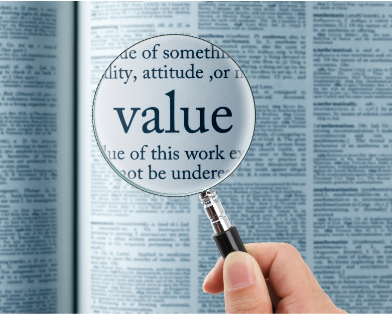 A Southern Oregon photo manager shows the word "value" under a magnifying glass to demonstrate that sometimes we need to look at how we are treating what we say we value.