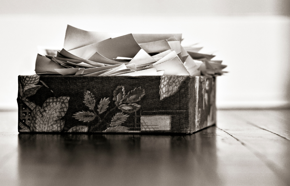 A Southern Oregon photo manager shows a box of unorganized photos.