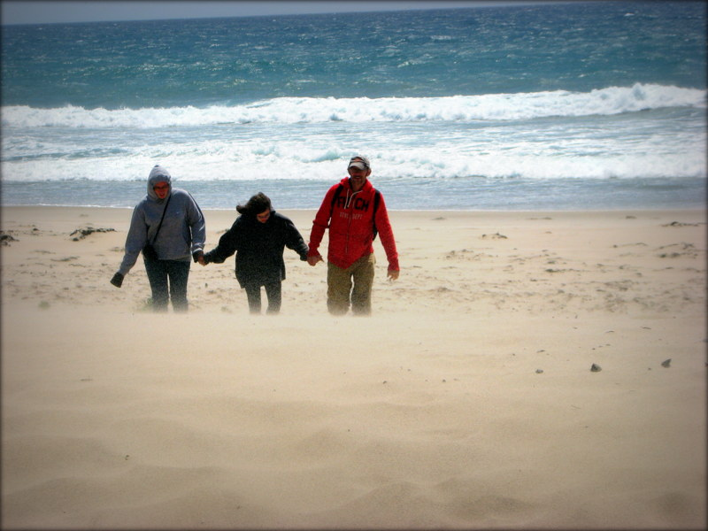 The author's family at the beach on a very windy day.